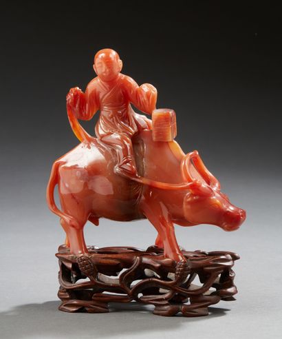 CHINE Buffalo surmounted by a child in sculpted agate. Carved and openworked wooden...