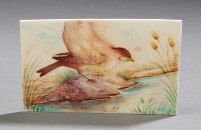 CHINE Petite plaquette en os sculpté à décor peint d'un oiseau près d'un cours d'eau....