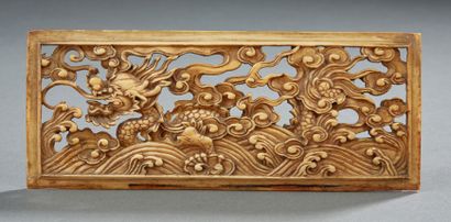 CHINE Rectangular ivory plaque with openwork carving representing a dragon rising...