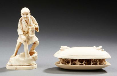 CHINE A carved ivory clam with an open mouth showing animated scenes of characters.
Work...