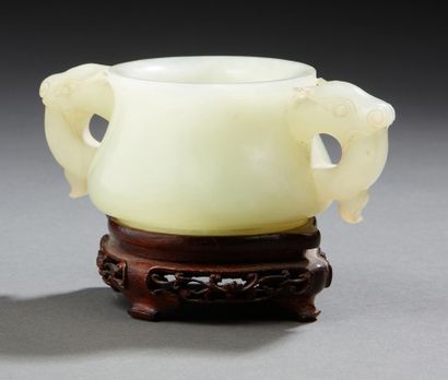 CHINE Small circular perfume burner in light green carved jade, the two handles showing...
