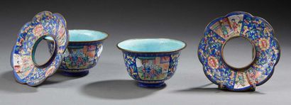 CHINE Two circular bowls and their saucers with openwork centre in painted enamels...