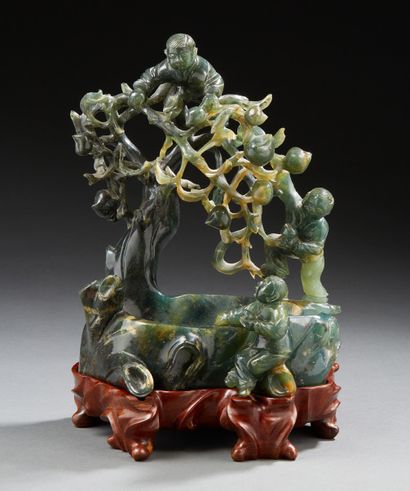 CHINE Carved spinach green jade group representing three children around a watering...