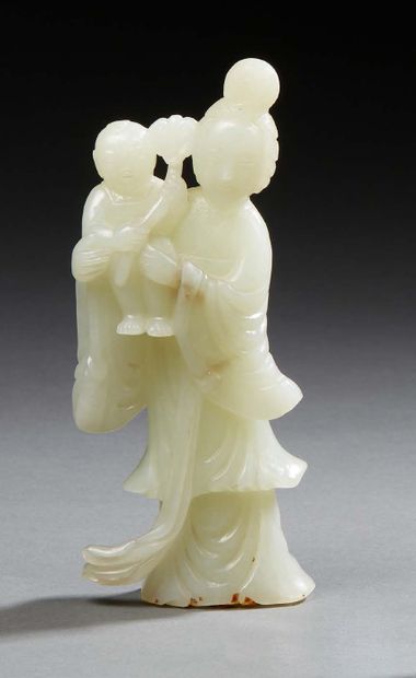 CHINE Carved light jade group representing the goddess Guanhyin holding a child in...