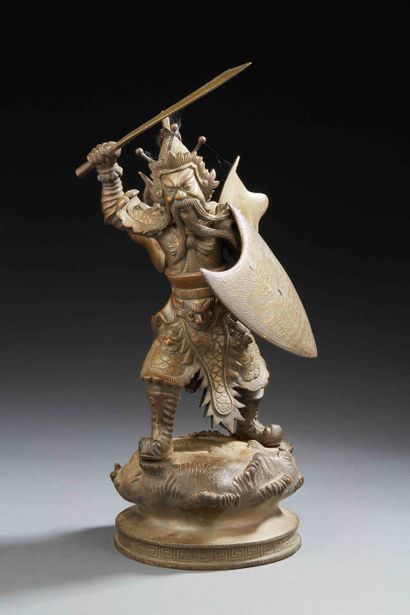 null CHINA - Bronze figure of a warrior standing on a mound brandishing a sword,...