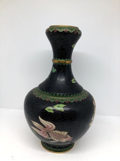 null CHINA


A cloisonné enamel vase with a fish design on a black background.


H....