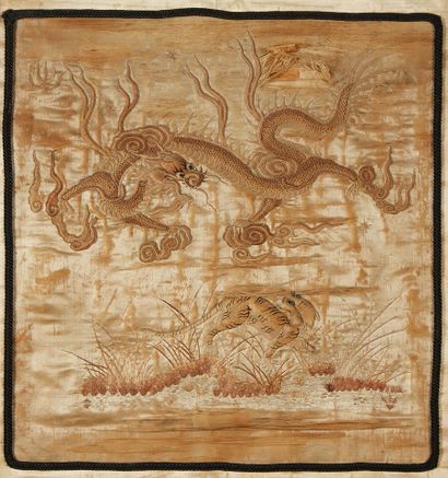CHINE Embroidery on silk showing a dragon on a cream background. Around 1900. (a...