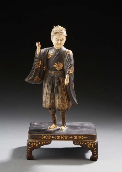 JAPON Carved wooden figure representing a figure with bloomers standing on a pedestal,...