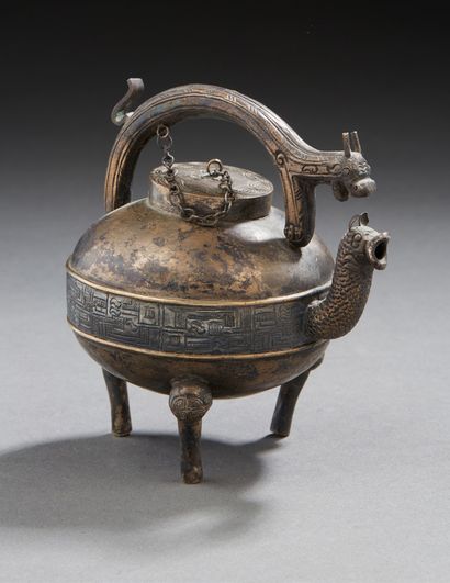 CHINE Small miniature teapot on three silver feet in the archaic style, the handle...