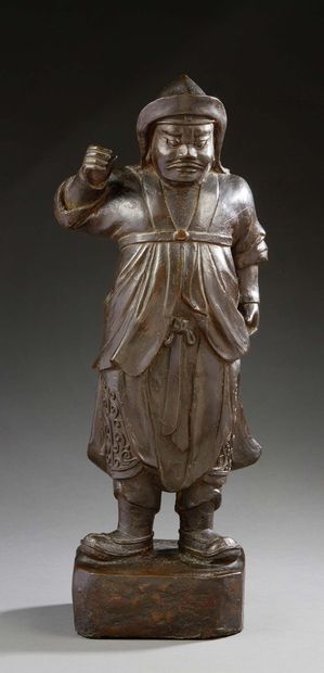 CHINE Brown patina bronze figure of a temple guardian standing on a square base.
Ming...