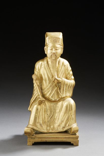 JAPON Gilded bronze figure of a seated dignitary holding a chassemouche and his beard...