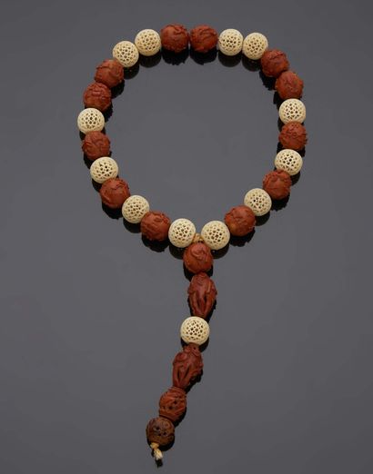 CHINE Rosary with openwork ivory beads alternating with corozo nut beads
Second half...