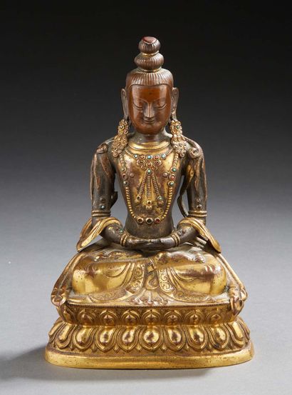 ART SINO-TIBETAIN A gilded brass figure of a seated bodhisattva in dhyanasana with...