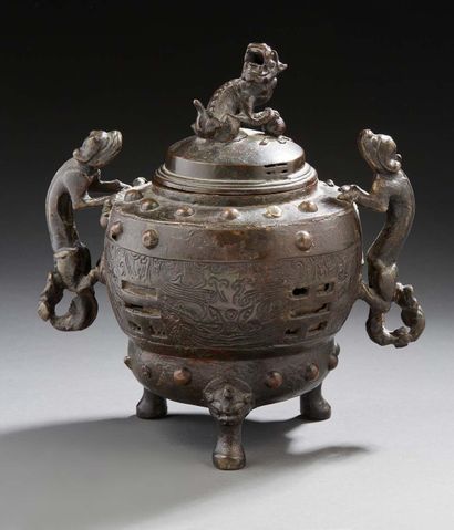 CHINE A bronze perfume burner with a brown patina, standing on three feet with handles...