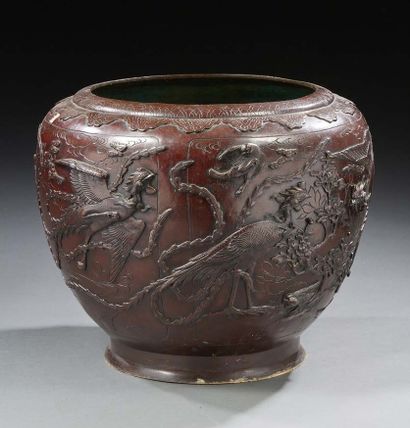 CHINE Important cache pot en bronze à patine brune à décor en relief d'oiseaux branchés.
Vers...