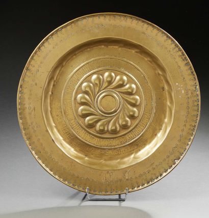 null * OFFERING PLAT in embossed brass; the border with a frieze of stylized flowers;...