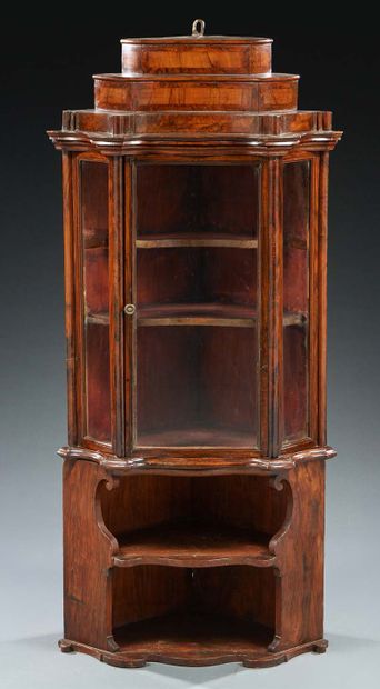 null A walnut and walnut veneer corner shelving unit; the upper part with steps opens...