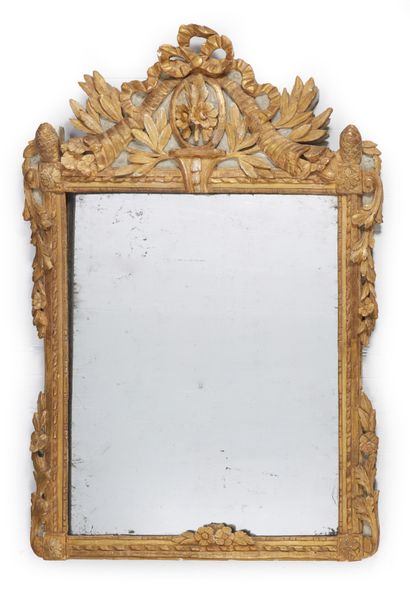 null Mercury mirror in a carved and gilded wood frame; the pediment centered with...