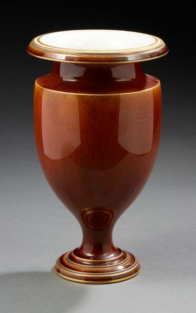null A golden brown porcelain vase with an ovoid body and a moulded pedestal.
Marked...