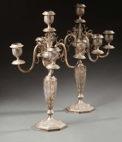 null Pair of five-light silver candelabras decorated with stylized foliage and birds.
Oriental...