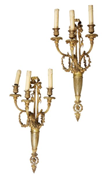 null Pair of three lights sconces in chased and gilded bronze ; the shaft in channel...