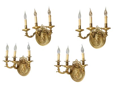 null FOUR FOUR chased and gilded bronze three-light sconces ; the bouquets held by...
