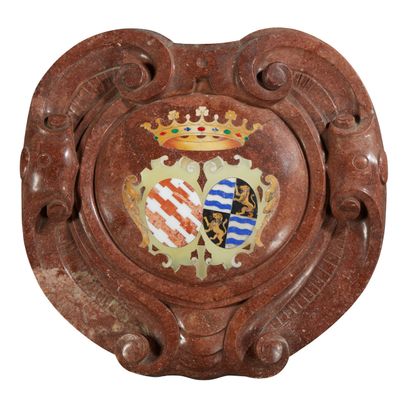A red marble CARTOUCHE decorated in the centre...
