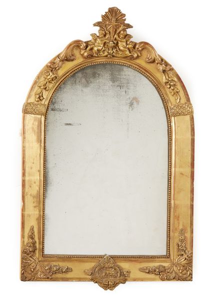 Wood and gilded stucco frame; the arched...