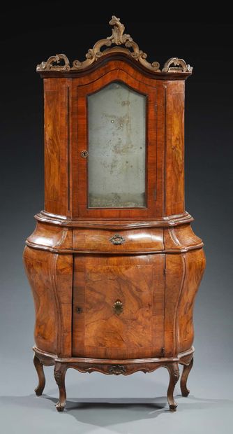 null A walnut and burr walnut veneered BODY FURNITURE; the upper part with a carved,...