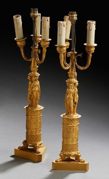 null A Pair of three-light chased and gilt bronze CANDELABRES ; the arms, in the...