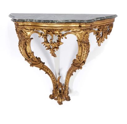 null RARE PAIR OF CONSOLES in carved and gilded wood; the belt with foliated and...