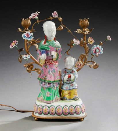 null A polychrome ceramic and gilt bronze CANDELA in the form of a group representing...