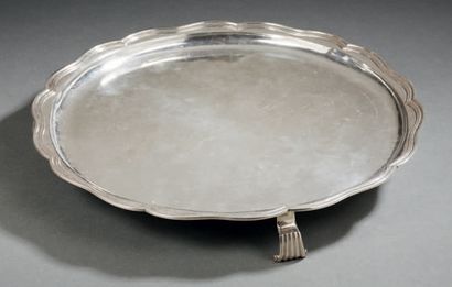 null A silver round presentation plate, of poly-lobed shape, bordered by a moulding...