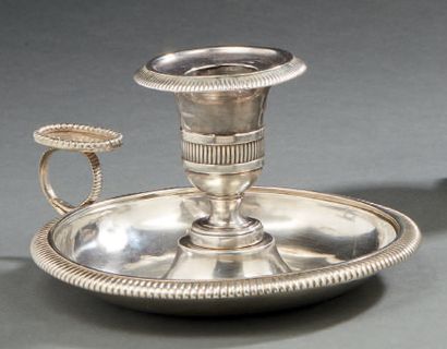 null A plain silver HAND CANDLE, the basin, the tap and the wick underlined by a...