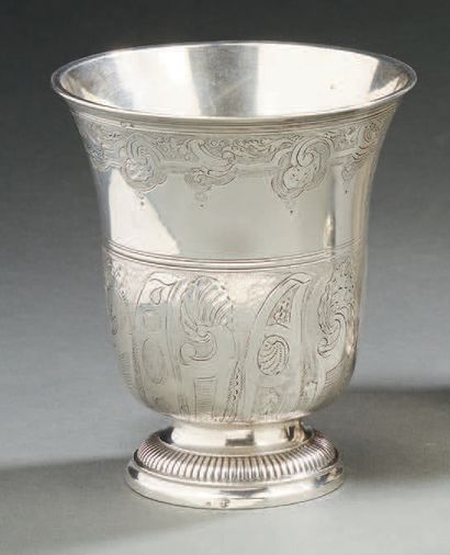 null A silver tulip-shaped TIMBALE resting on a gadrooned pedestal. The body is decorated...