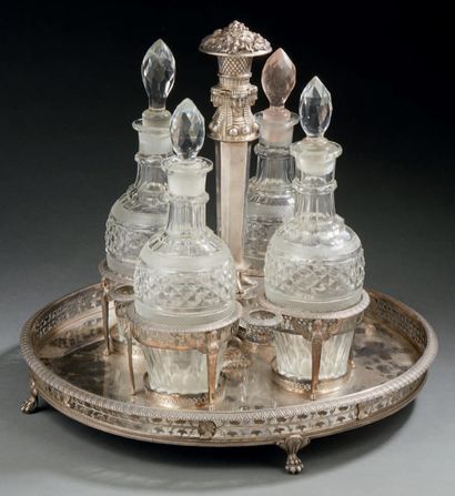 null A silver liquor cabinet or cabaret standing on four claw feet. The openwork...