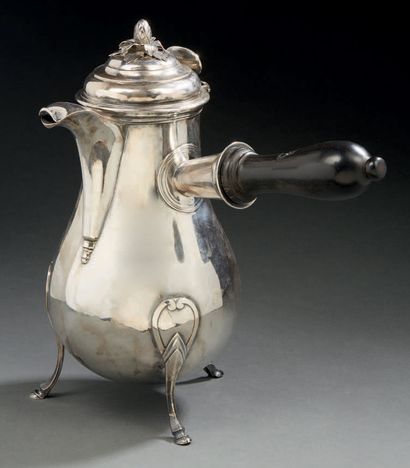 null A silver TRIPOD JUGGING BOTTLE, standing on three curved legs with a hoofed...