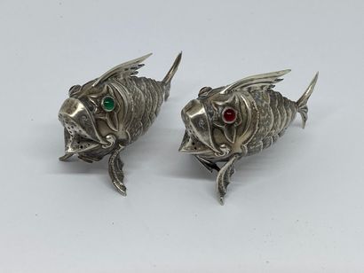 null PAIR OF SALONS in silver representing articulated fishes, the eyes in colored...
