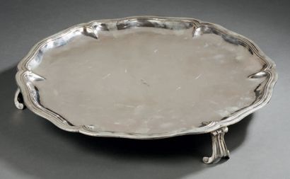  SALVER OR PLAT resting on three scrolled feet, the edge chantopurnate and molded...