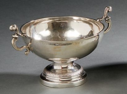null A silver WEDDING CUP. It rests on a circular pedestal moulded with a frieze...