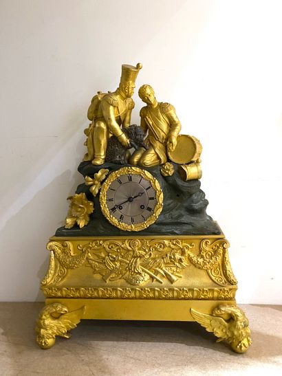 null Chased bronze clock with two green and gilded patinas resting on front legs...