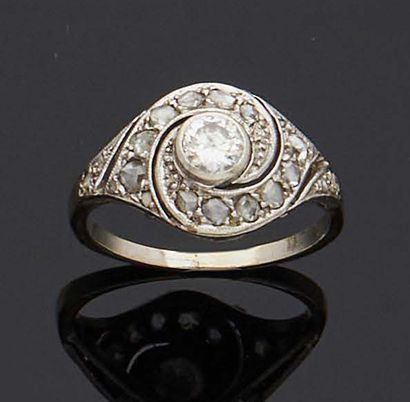null Platinum and 750 mm white gold tourbillon ring, centered on a half-cut diamond...