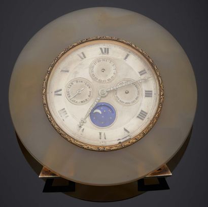 null Table complications CLOCK, consisting of a flat blond agate disk, centered on...