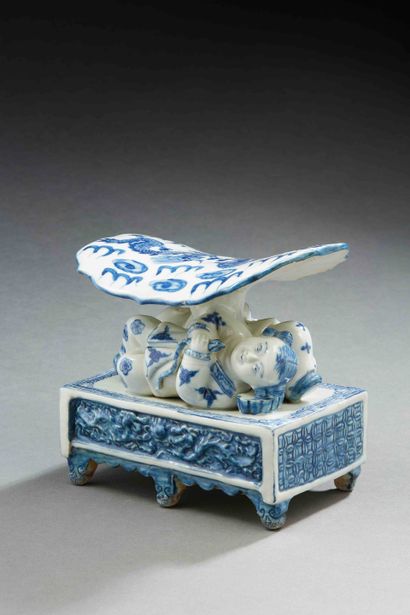 null CHINA

Porcelain headrest representing a reclining figure under a water lily...