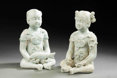 null CHINA

Two porcelain figurines of seated children with fish and lotus flowers...