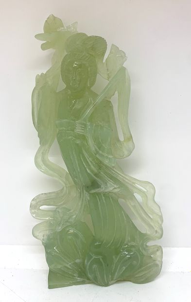 null Sculpture of a goddess in light green hard stone holding a lotus flower.

H....
