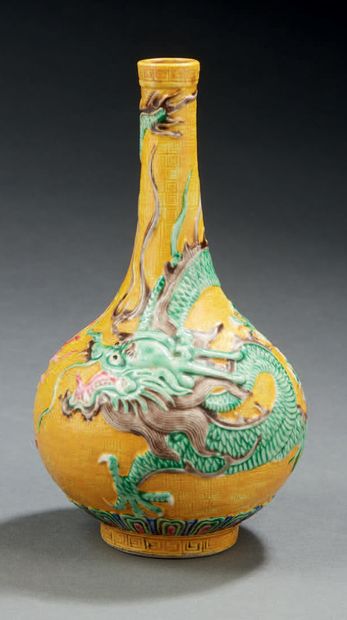 CHINE Petit vase à long col étroit à fond jaune décoré en léger relief en polychromie...