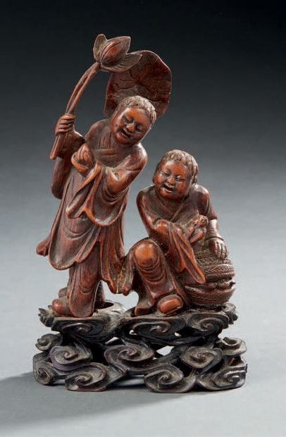 CHINE Small carved bamboo group representing two lohans, one trying a longevity peach...