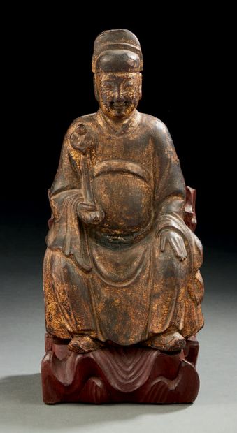 CHINE Wooden figurine, partly gilded, representing a dignitary seated on a vegetal...