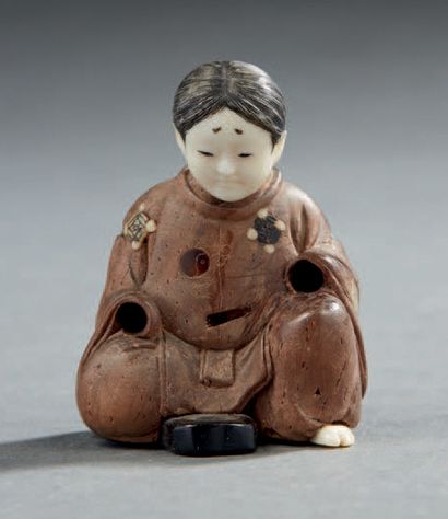 JAPON Netsuké représentant une femme assise en bois sculpté, la robe incrustée de...